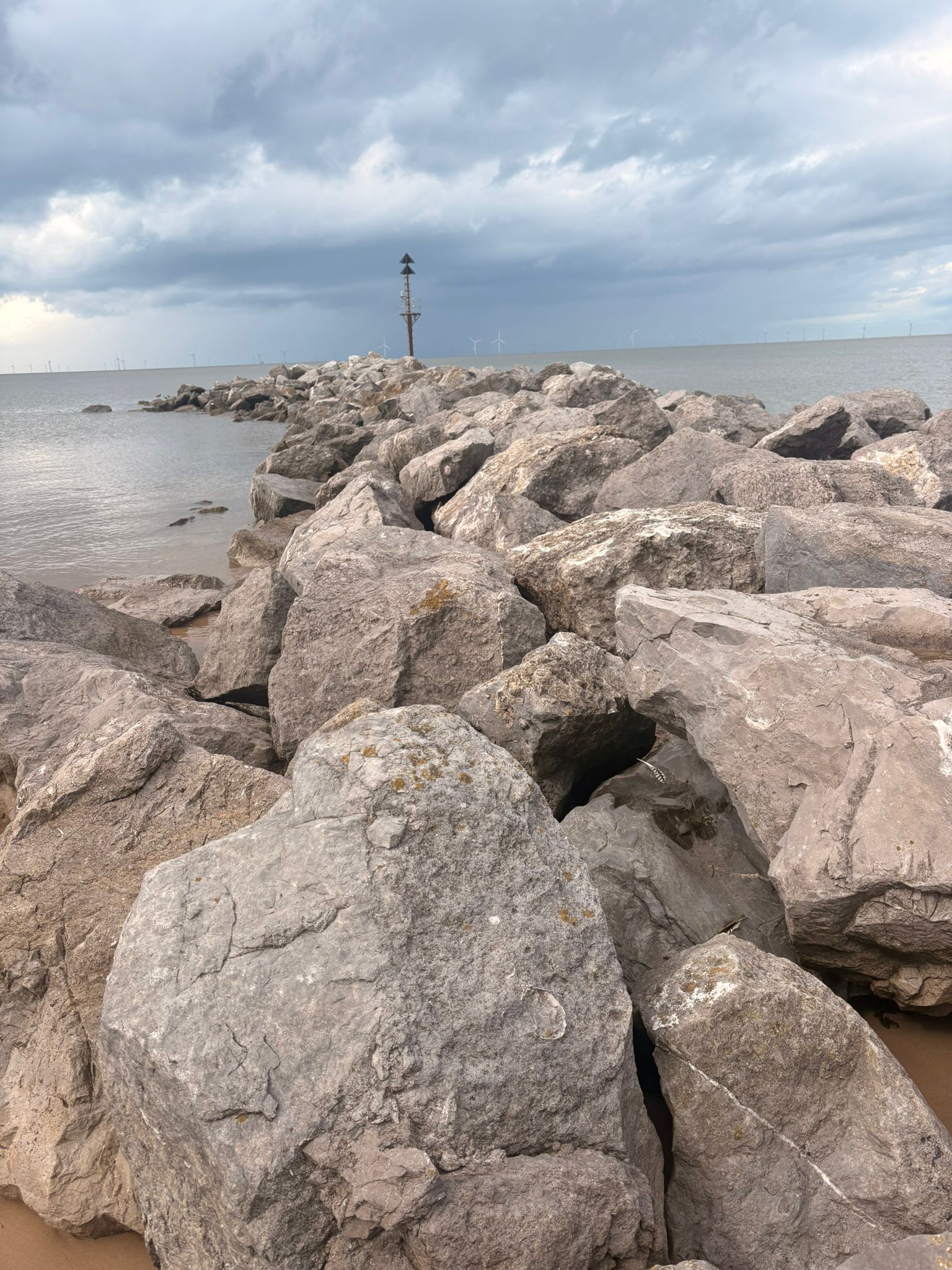A wooden groyne and rockpools on the Wirral shore